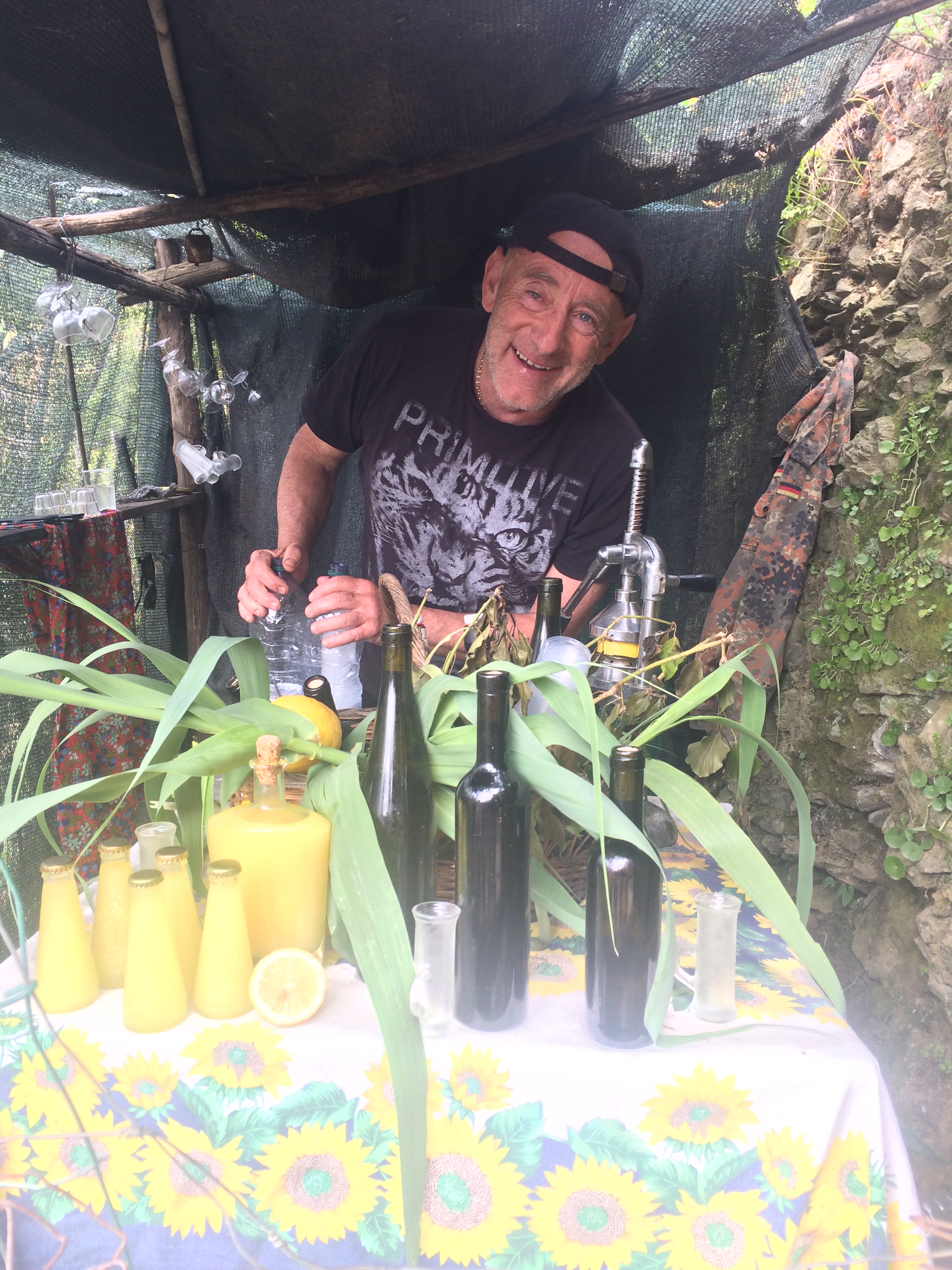 Local selling Lemoncello in Monterosso, Cinque Terre, Italy