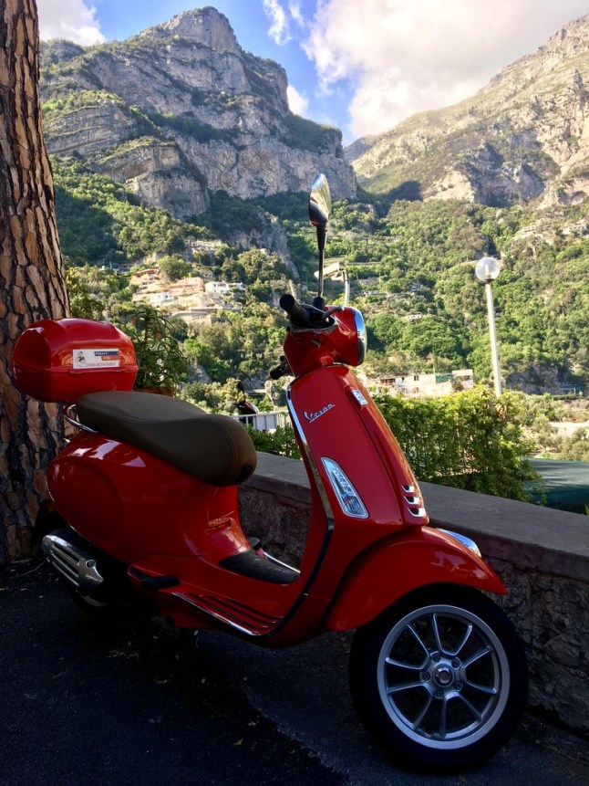 Vespa cliffside in Positano